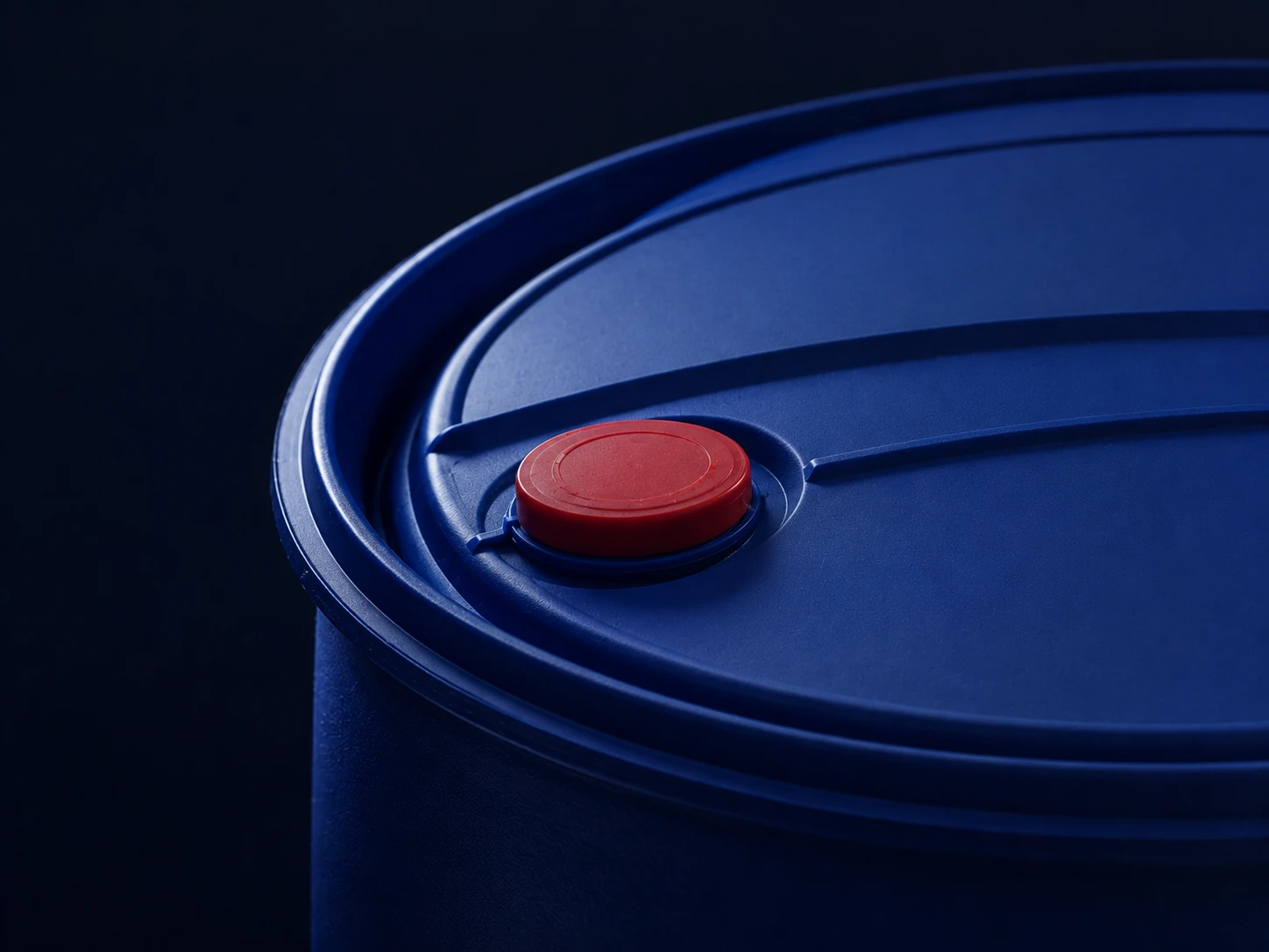 Close view of a blue industrial chemical drum with a red closure