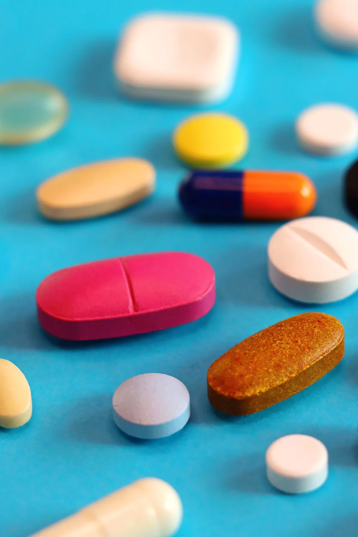 Tablets and capsules on a blue background