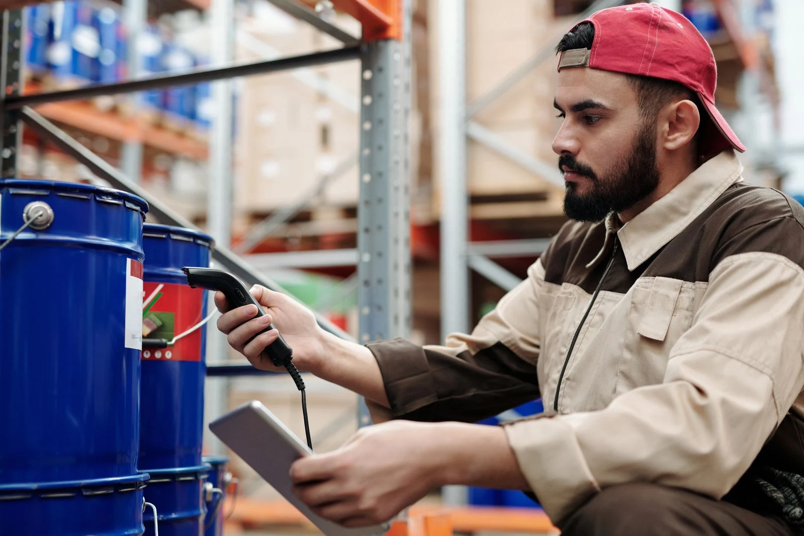 Warehouse worker checking a barrel label with a handheld scanner
