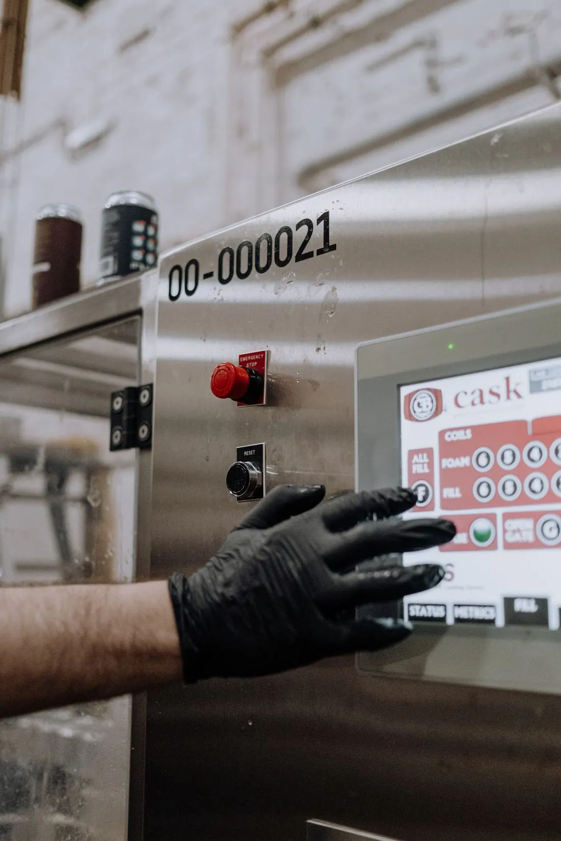 Gloved equipment operator using an industrial control panel